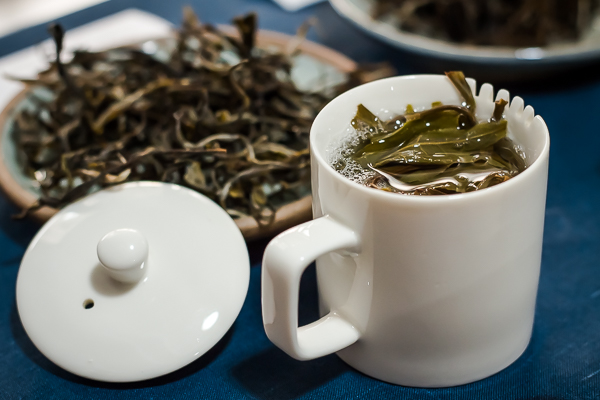 Steeping tea in tea-tasting cup. Young pu-erh from Thailand.